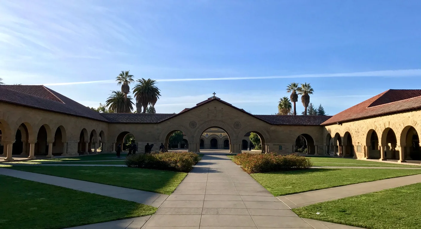 Stanford University's historic Main Quad with palm trees and a clear blue sky