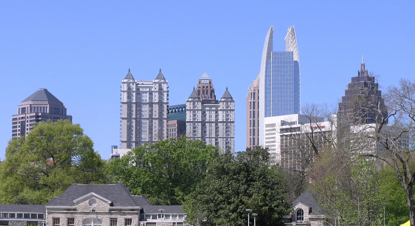 The Midtown Atlanta skyline rising above the trees in Piedmont Park